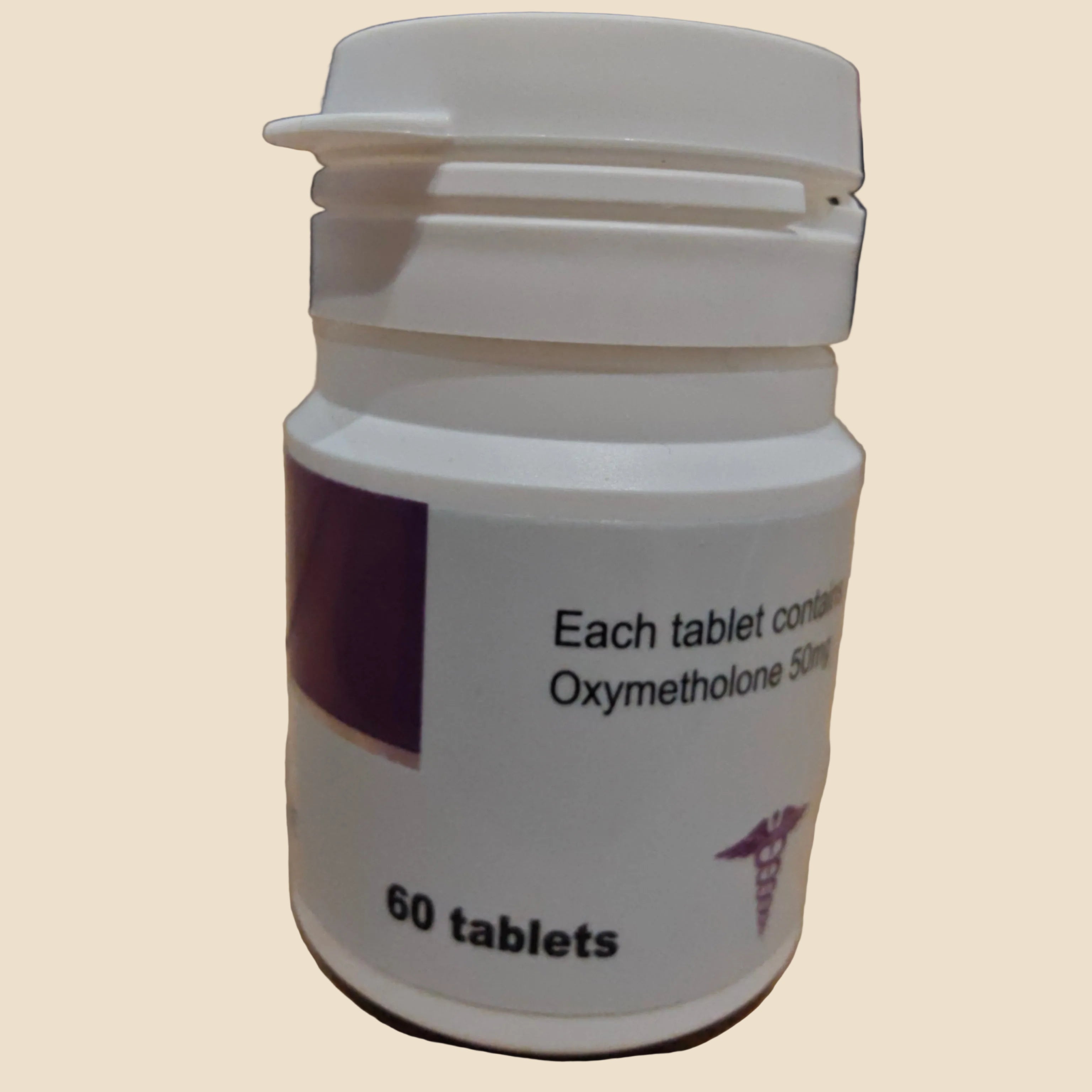 Medication bottle labeled with 'Oxymetholone' on a wooden surface
