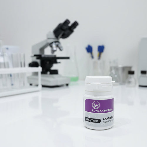 Bottle with purple label on a white surface with a blurred microscope in the background
